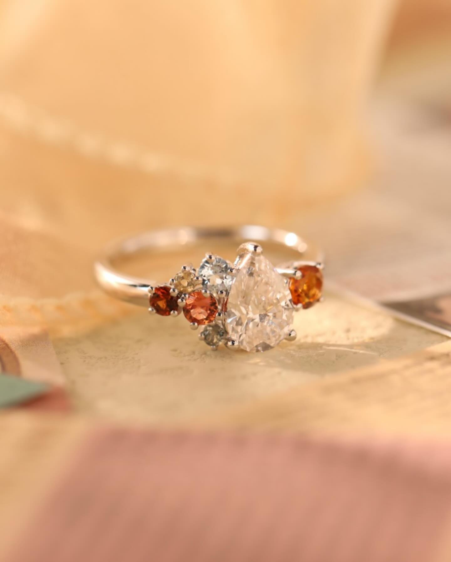 Pear diamond with garnet cluster ring